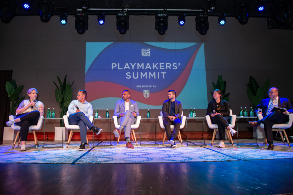 A picture of the stage and speakers at the 2023 Playmakers' Summit